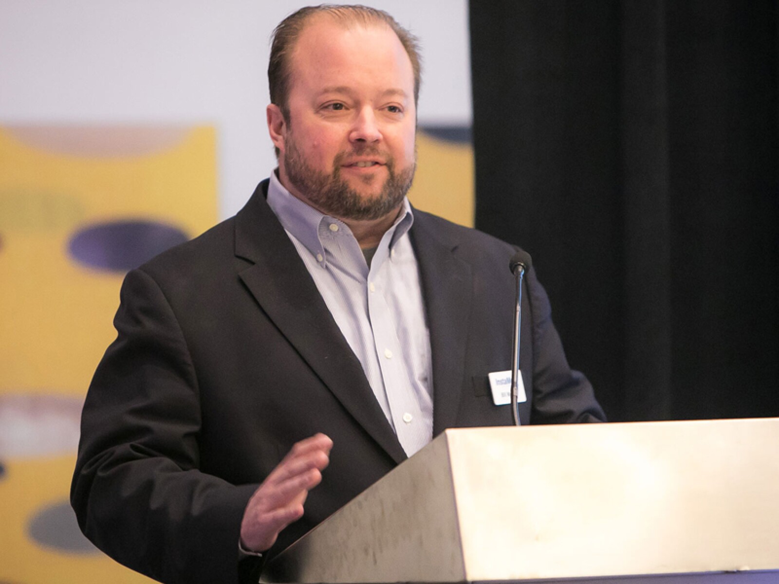 InstaMed co-founder Bill Marvin speaking at a lectern