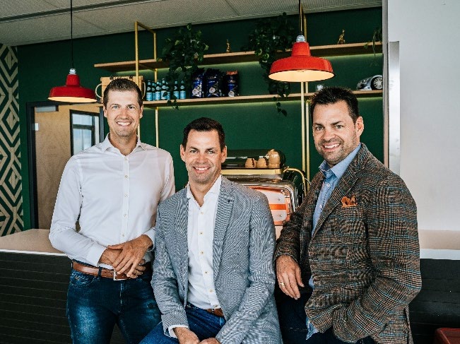 INSTART management pictured together in a café-like workplace
