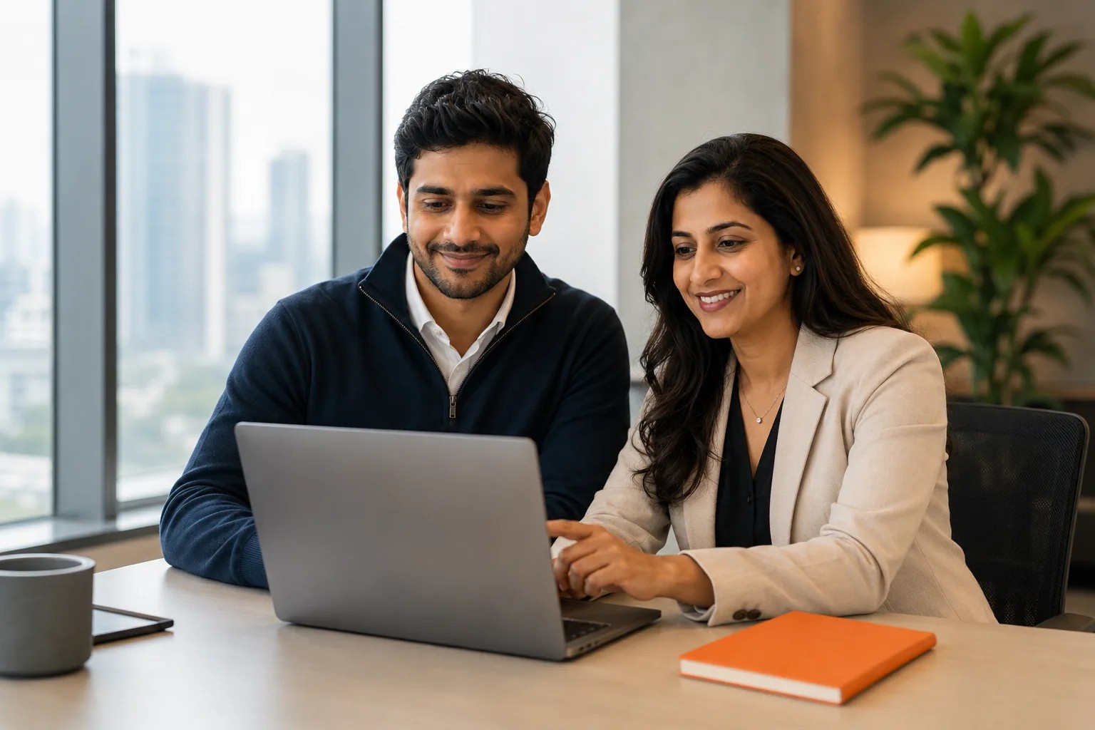 Two colleagues at a laptop in an office scene on InstaSafe's about page