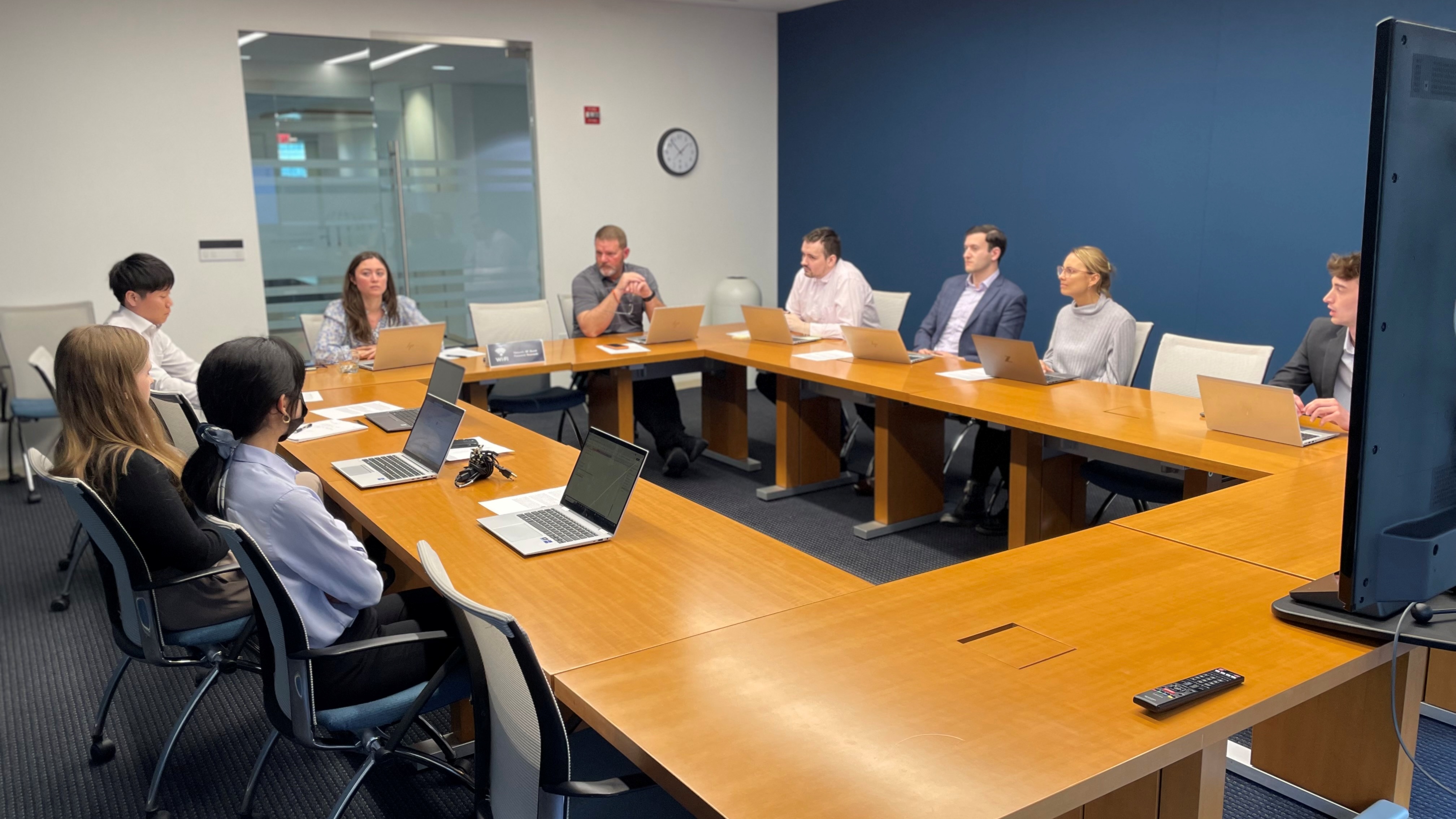 IIF staff seated around a conference table with laptops during a Staff Advisory Committee meeting