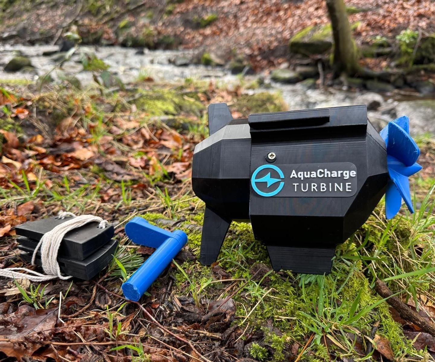 AquaCharge portable water turbine beside a stream