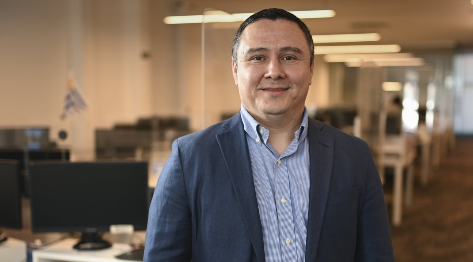 Ronald Alvarenga standing in an office, photographed for the 2024 acquisition coverage