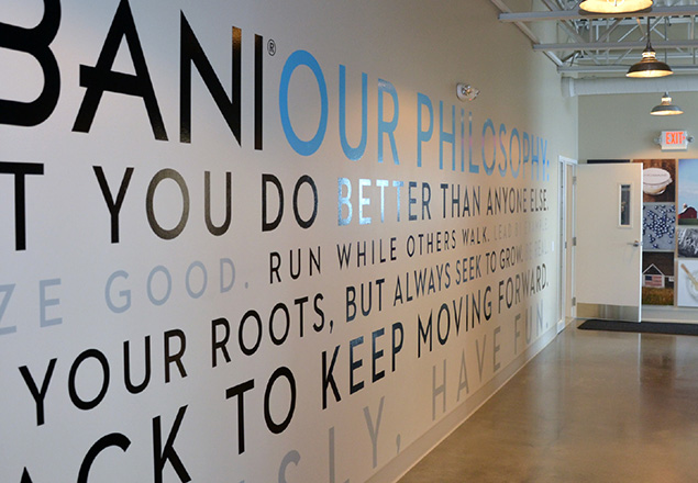 A branded interior corridor with large typography across the wall
