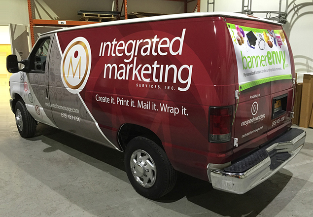 A red van wrapped in Integrated Marketing Services branding