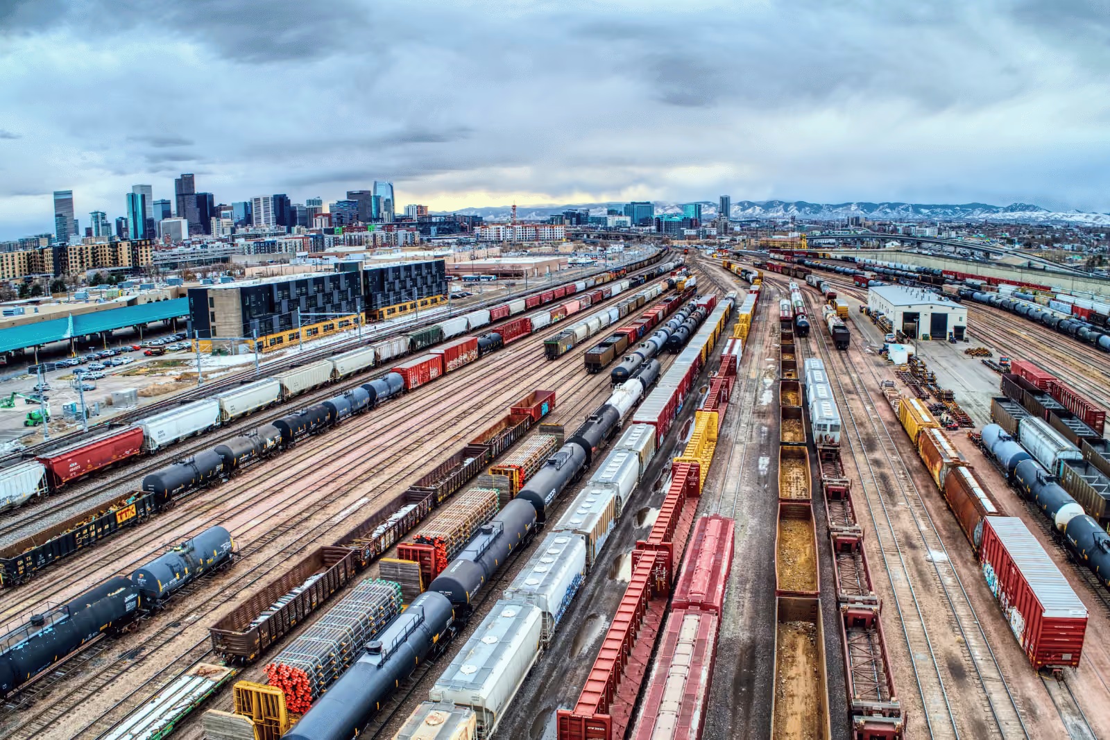 Freight cars spread across parallel tracks in a Denver rail yard