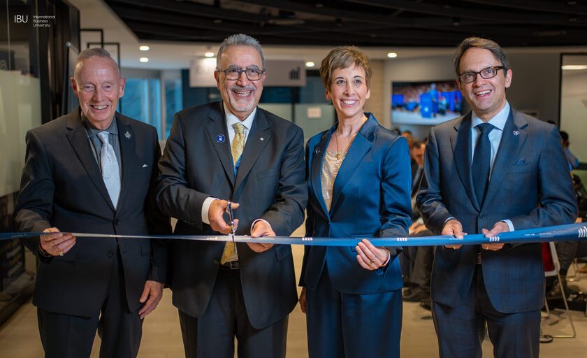 Guests cut a ribbon at the opening of International Business University's new Toronto campus