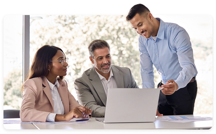 Intuit marketing photograph of three people discussing work around a laptop