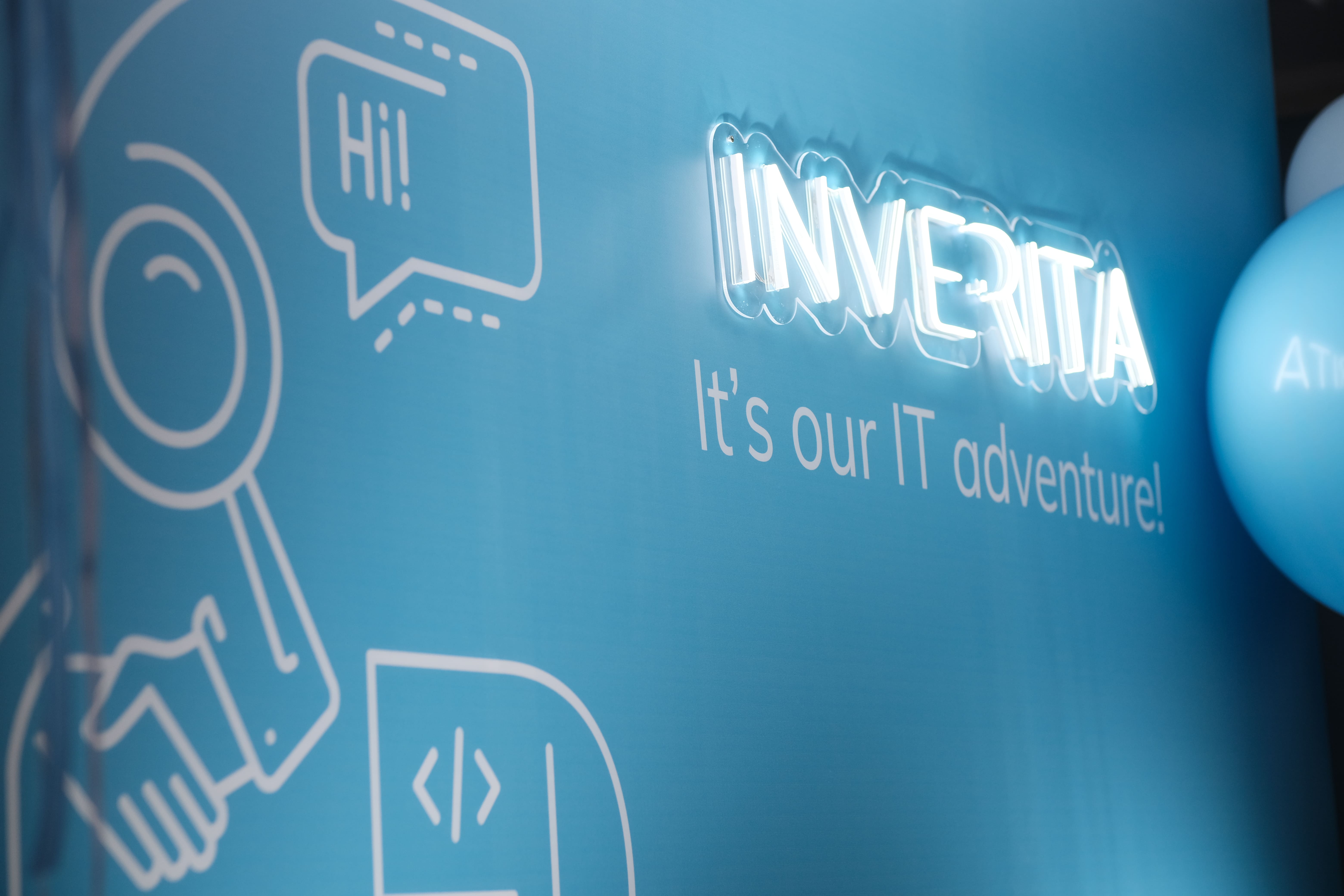 Illuminated inVerita lettering and illustrated wall in the company’s team-page photograph