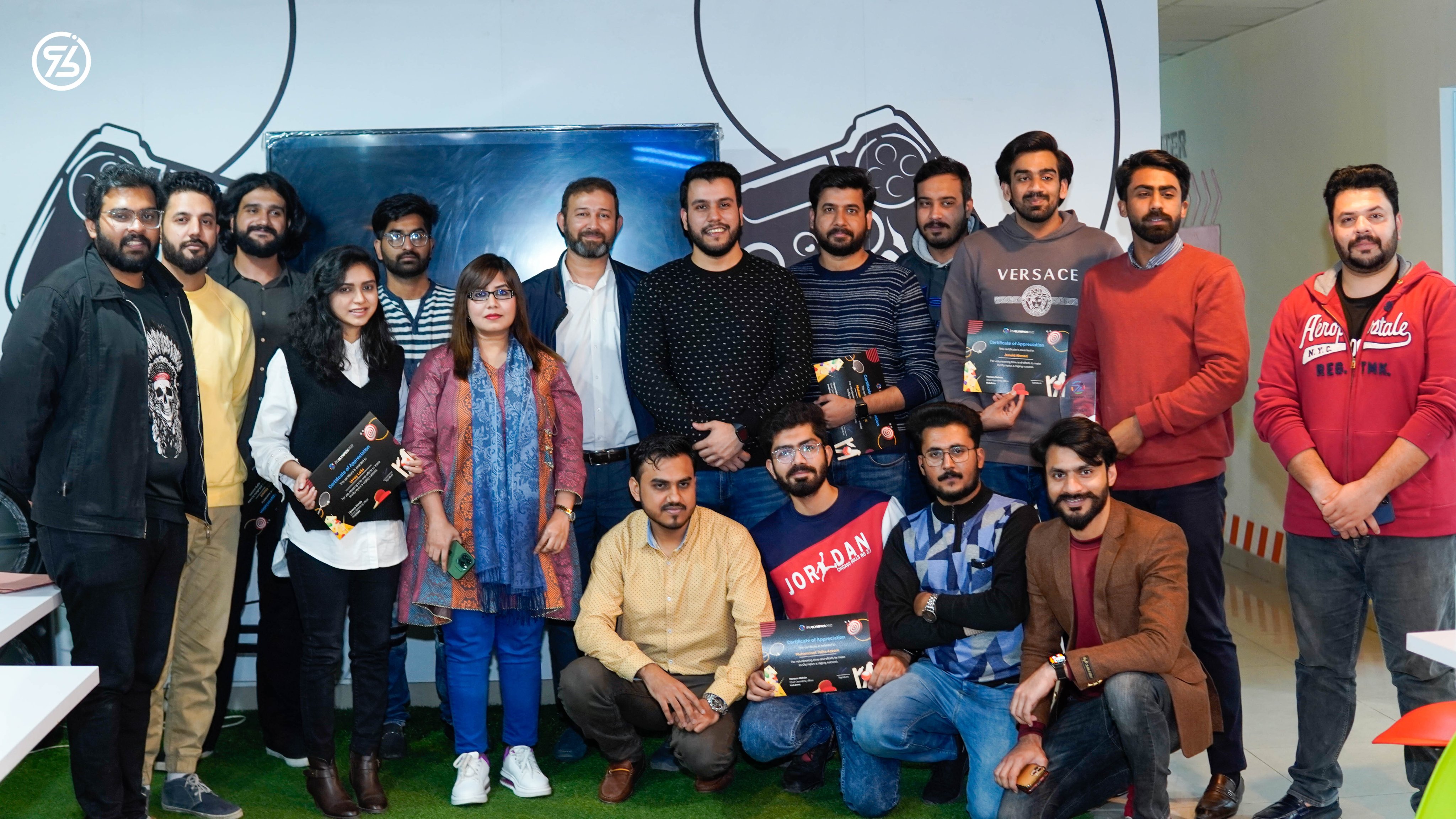 InvoZone colleagues holding appreciation certificates during an office gathering
