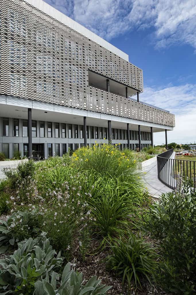Data Valley building with a patterned facade and planted outdoor terrace
