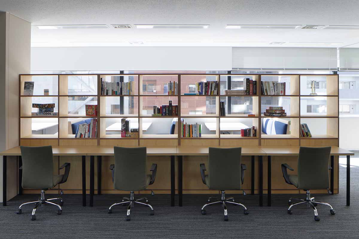 YOUTRUST counter workspace with four chairs and open wooden bookshelves