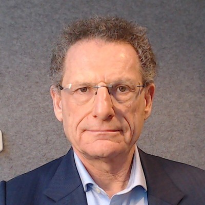 Andrew Bud, founder and CEO of iProov, wearing glasses and a dark jacket
