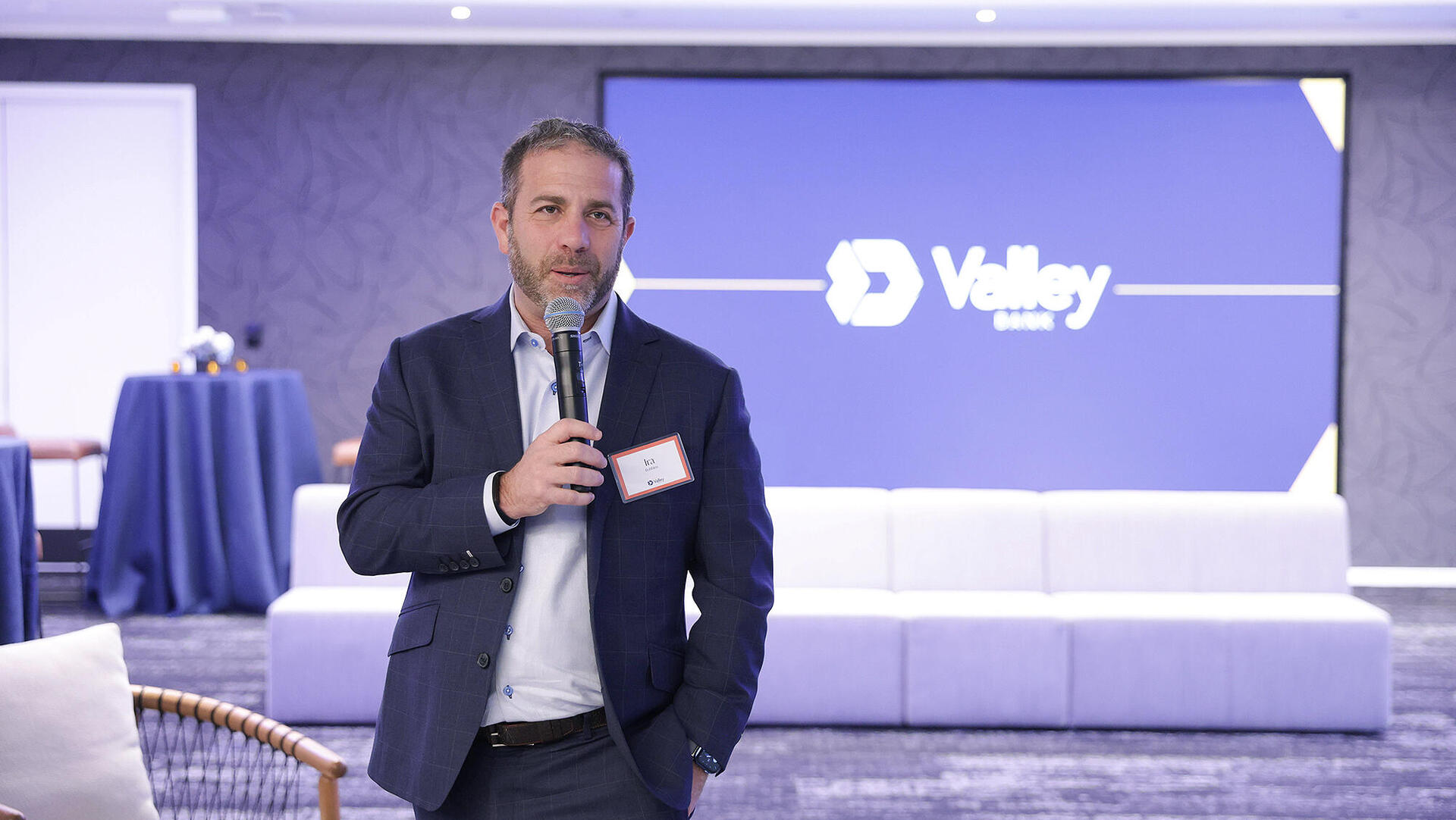 Ira Robbins speaking into a microphone at Innovation at NASDAQ in New York