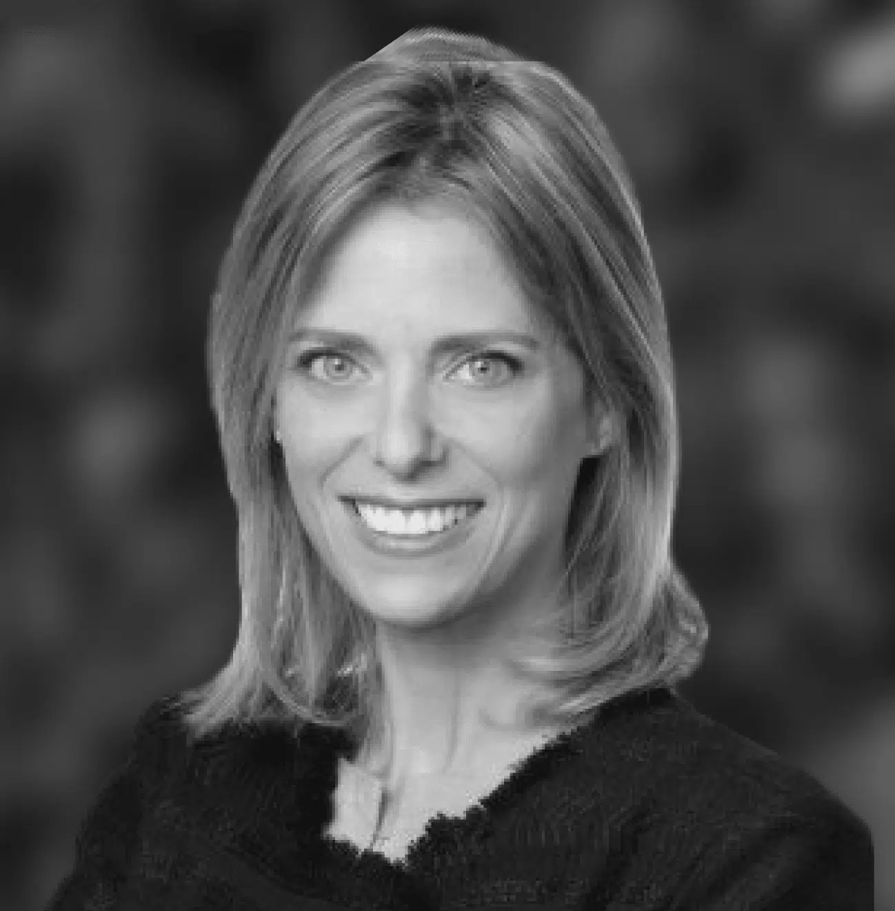 Black-and-white portrait of Irit Singer smiling at a Windward event