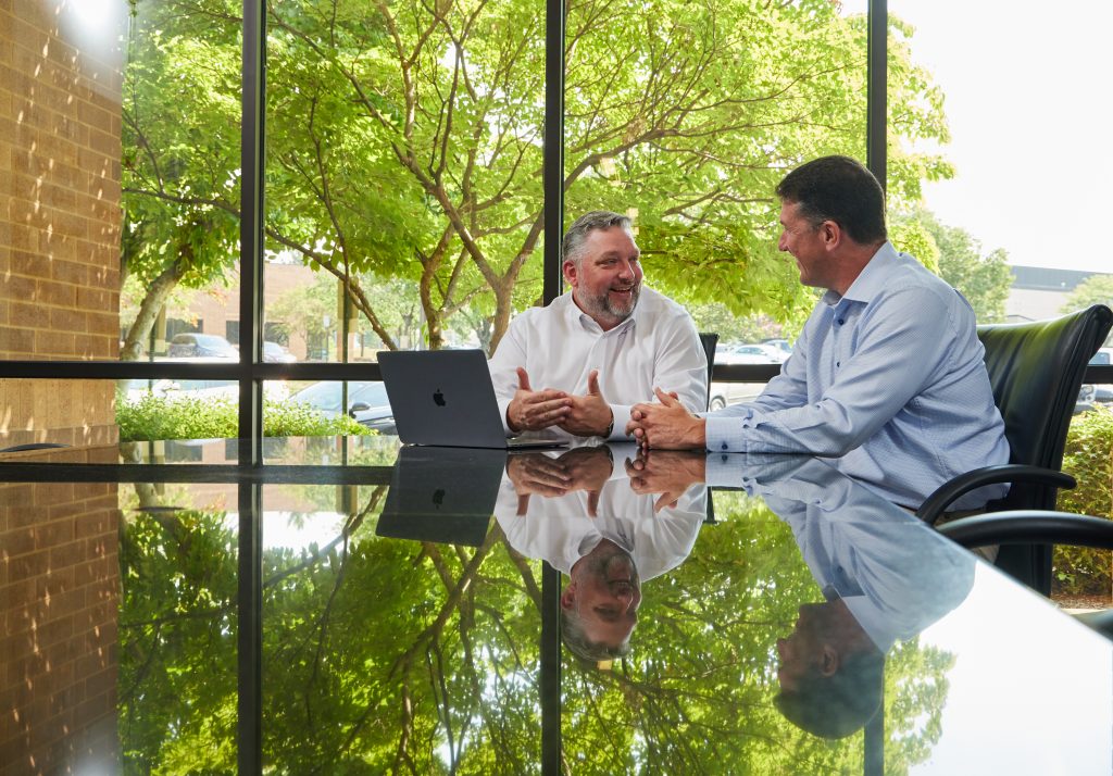 Matt Marzullo at left and Jeff Ostenso at right collaborating in a conference room