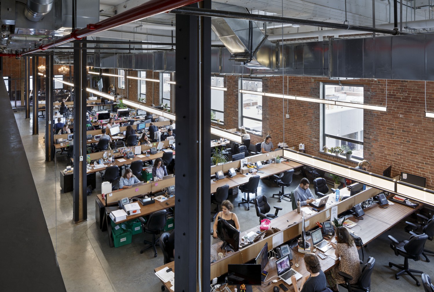 VICE office with open desks, employees and exposed overhead ducts