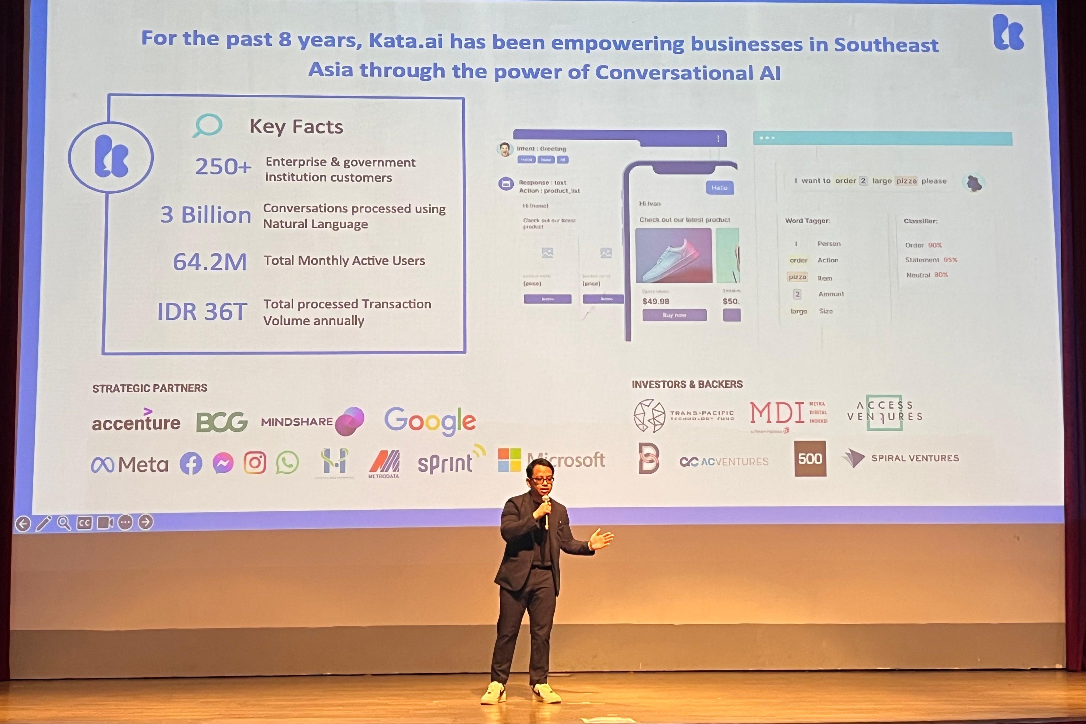 Irzan Raditya holding a microphone while presenting Kata.ai at SMBC TechConnect