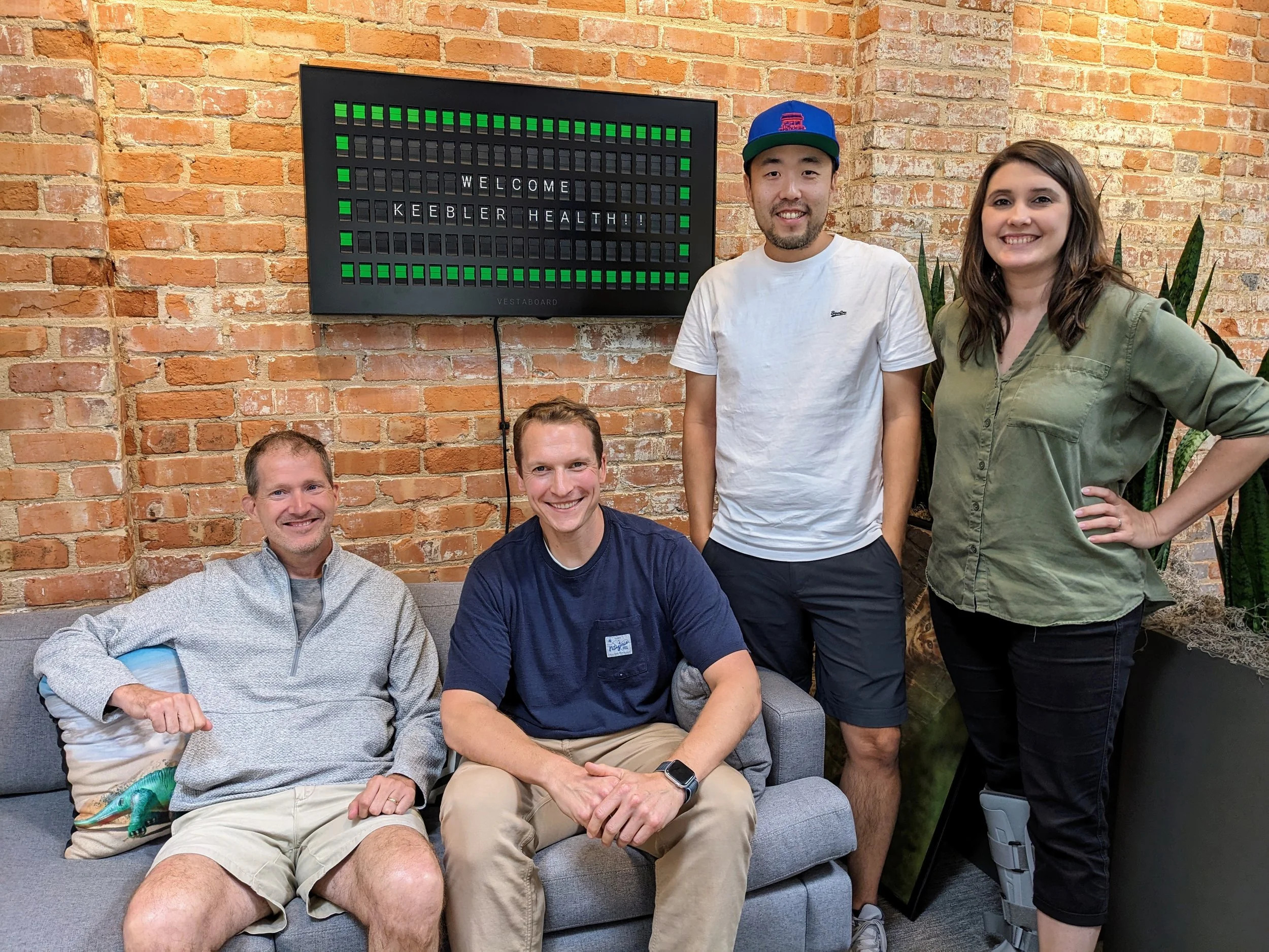 Isaac Park and the early Keebler Health team gathered in a brick-walled Durham office