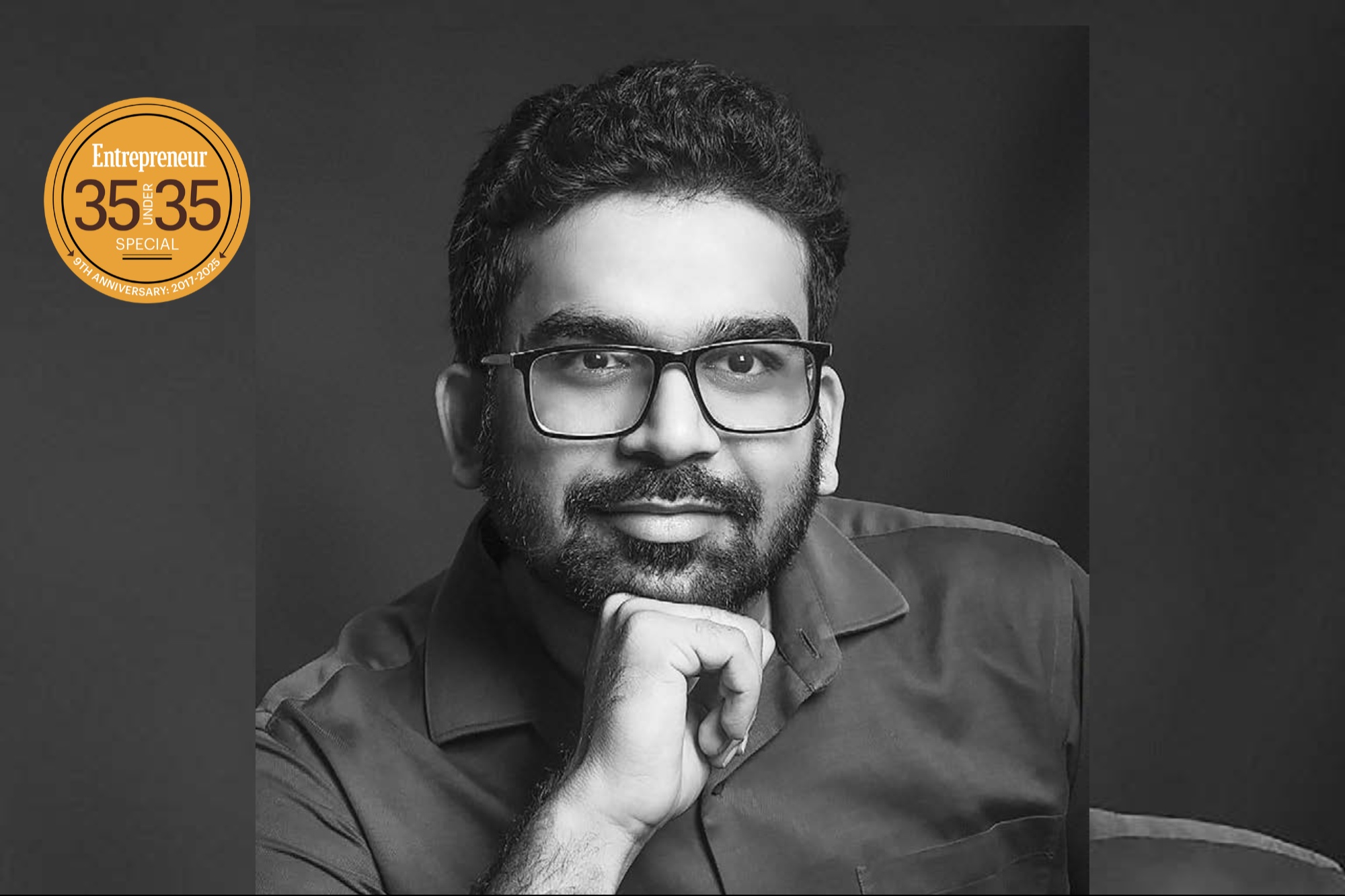 Black-and-white press photograph of Ishendra Agarwal wearing glasses, with an Entrepreneur India 35 Under 35 badge