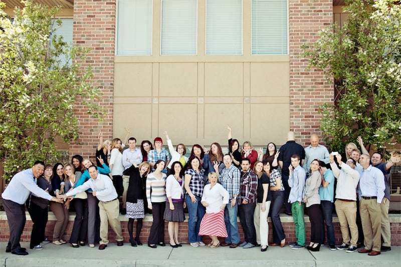 ApplicantPro team gathered outside a brick building