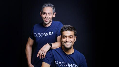 TailorMed co-founders Adam Siton and Israel Dvorsky wearing TailorMed shirts against a dark background