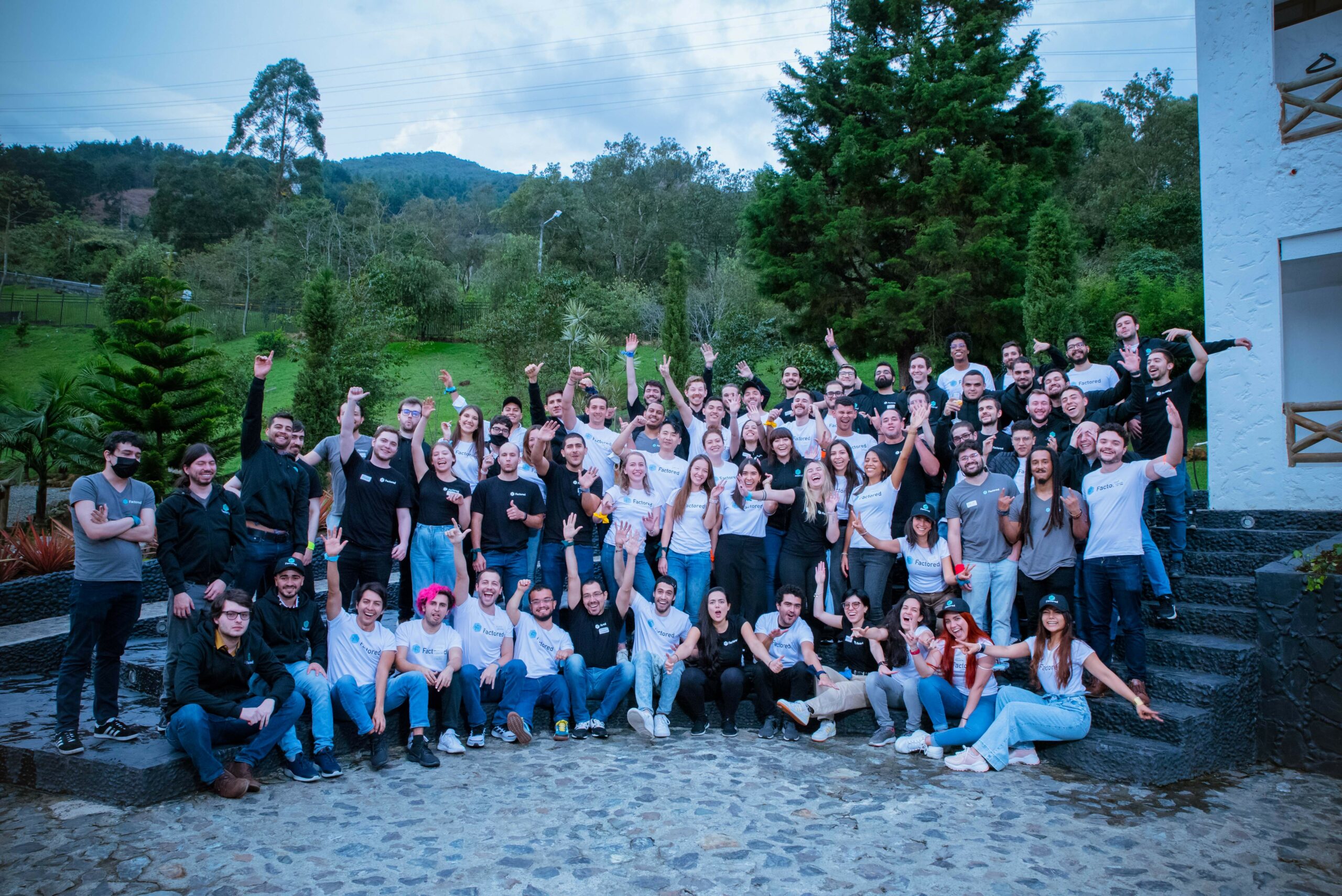 A large group of Factored team members gathered outdoors in Colombia