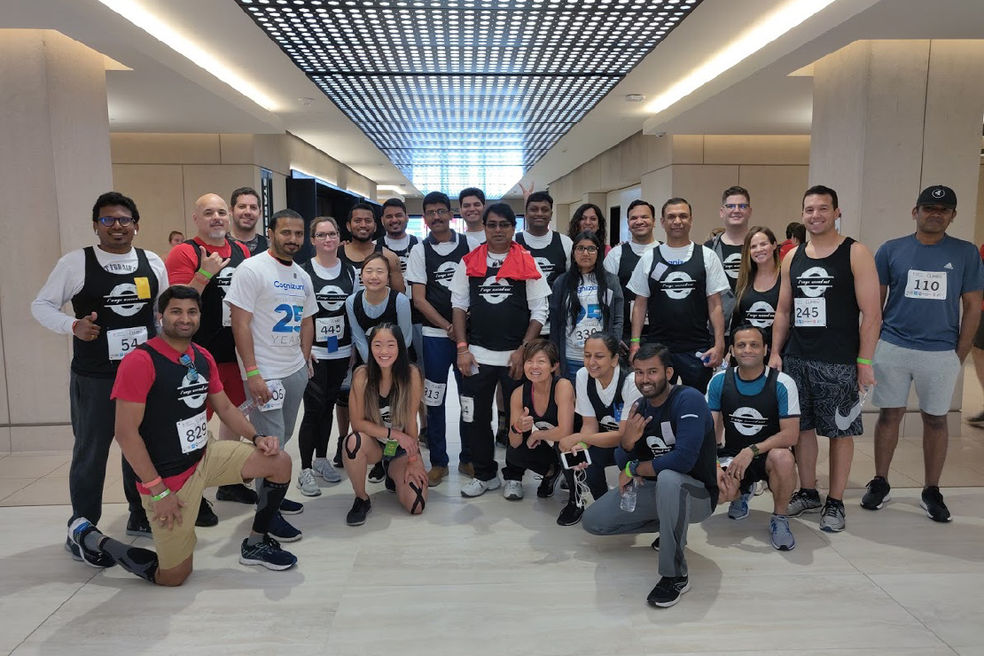 A group in athletic clothing and race bibs pictured on itsoli’s company events page