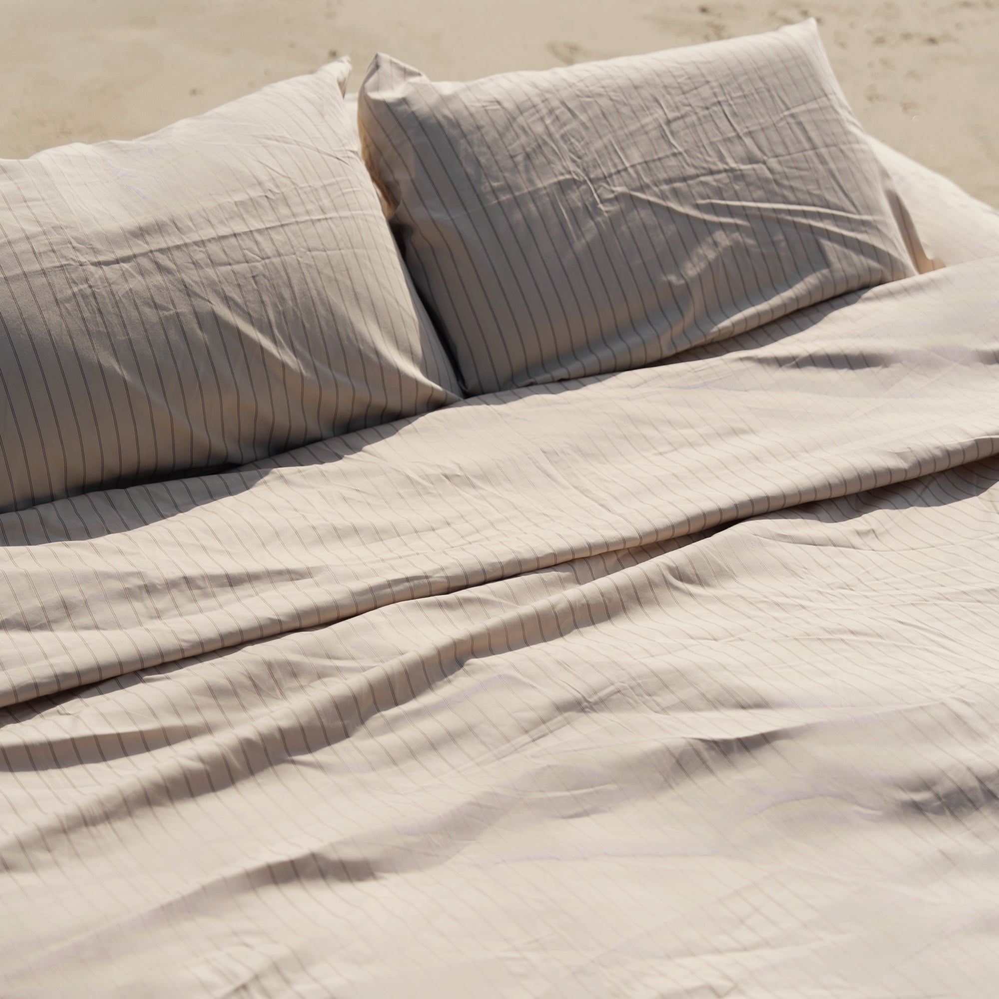 Italic bedding in oat tones, shown in an official product photograph