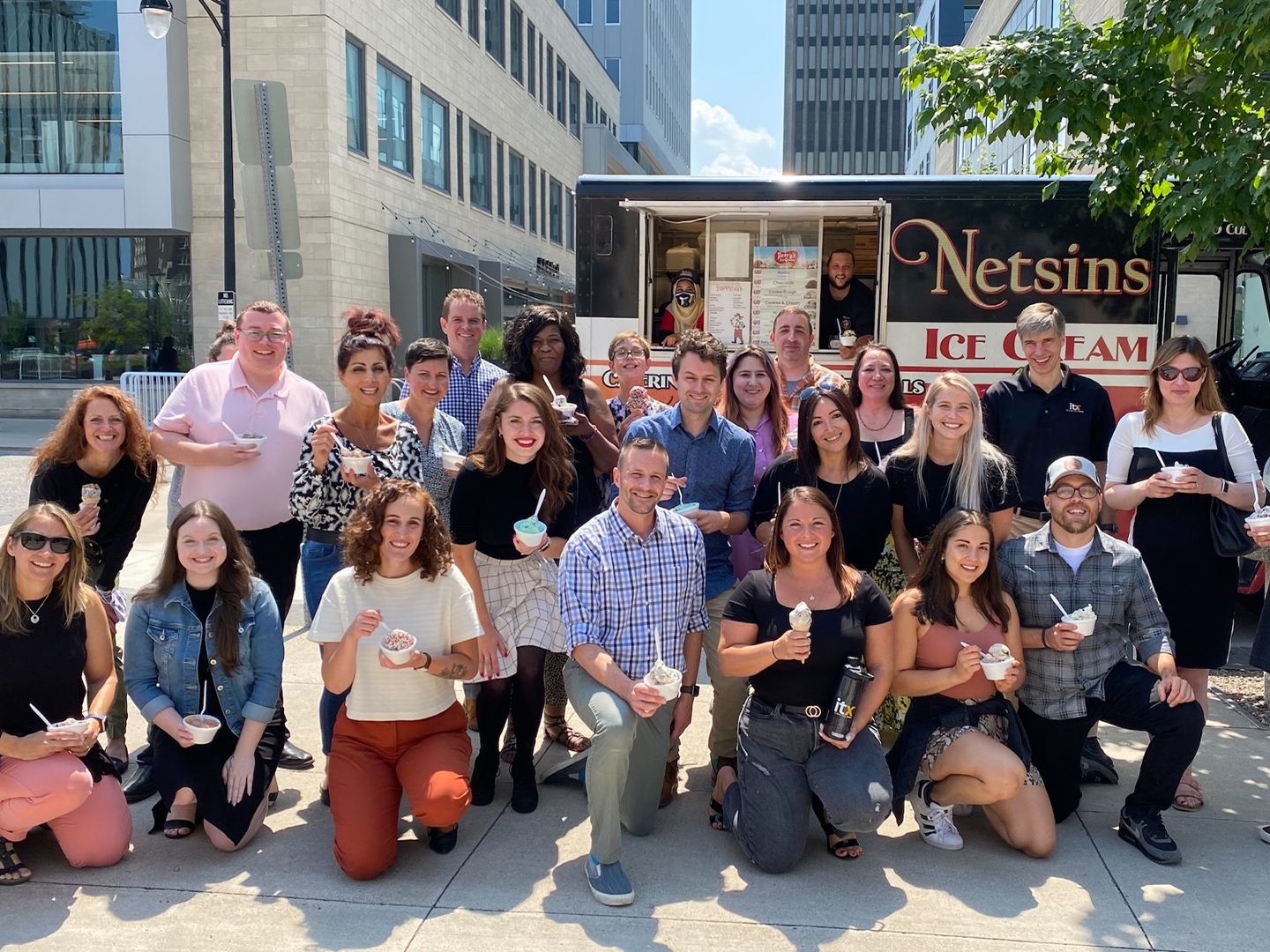 ITX team members gathered with ice cream outside their Rochester headquarters