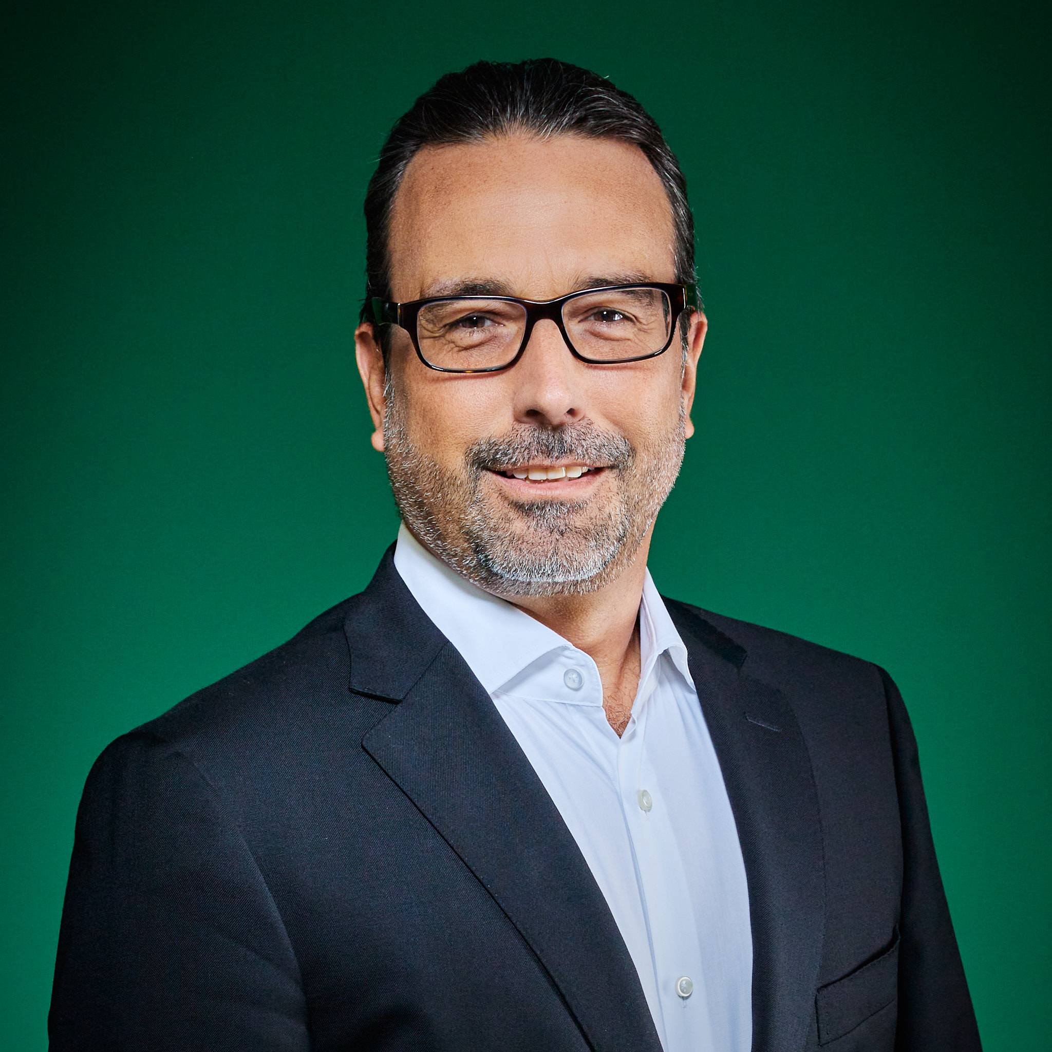 Edgar Osuna, iuvity’s Chief Data and Analytics Officer, wearing glasses against a green background