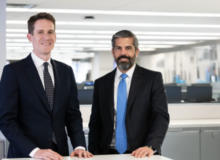 Joseph Dunn on the left and Jack Neumark on the right, standing in a Fortress office