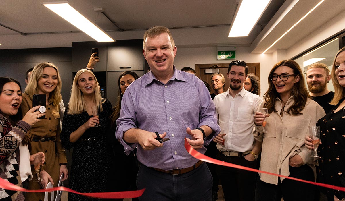 Jack Welde cuts a red ribbon surrounded by colleagues at Smartling’s Dublin office opening