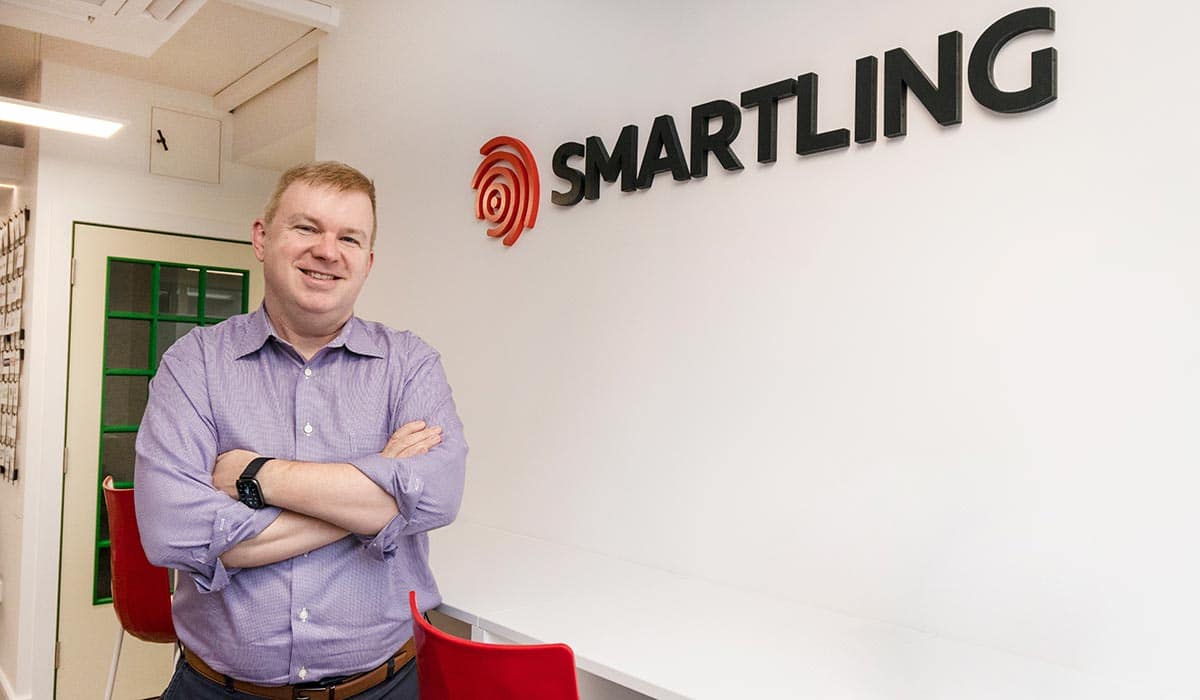 Jack Welde beside the Smartling sign inside the company’s Dublin office