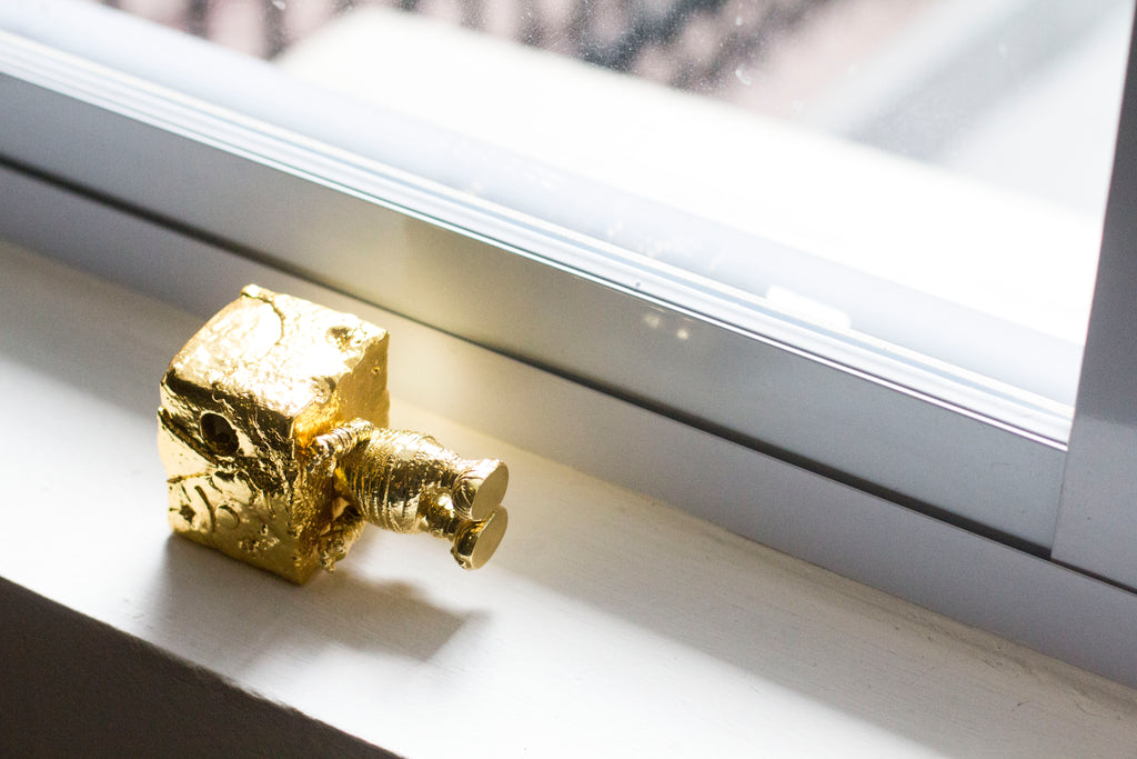 A gold-coloured camera-shaped object on the Mighty Jaxx studio windowsill