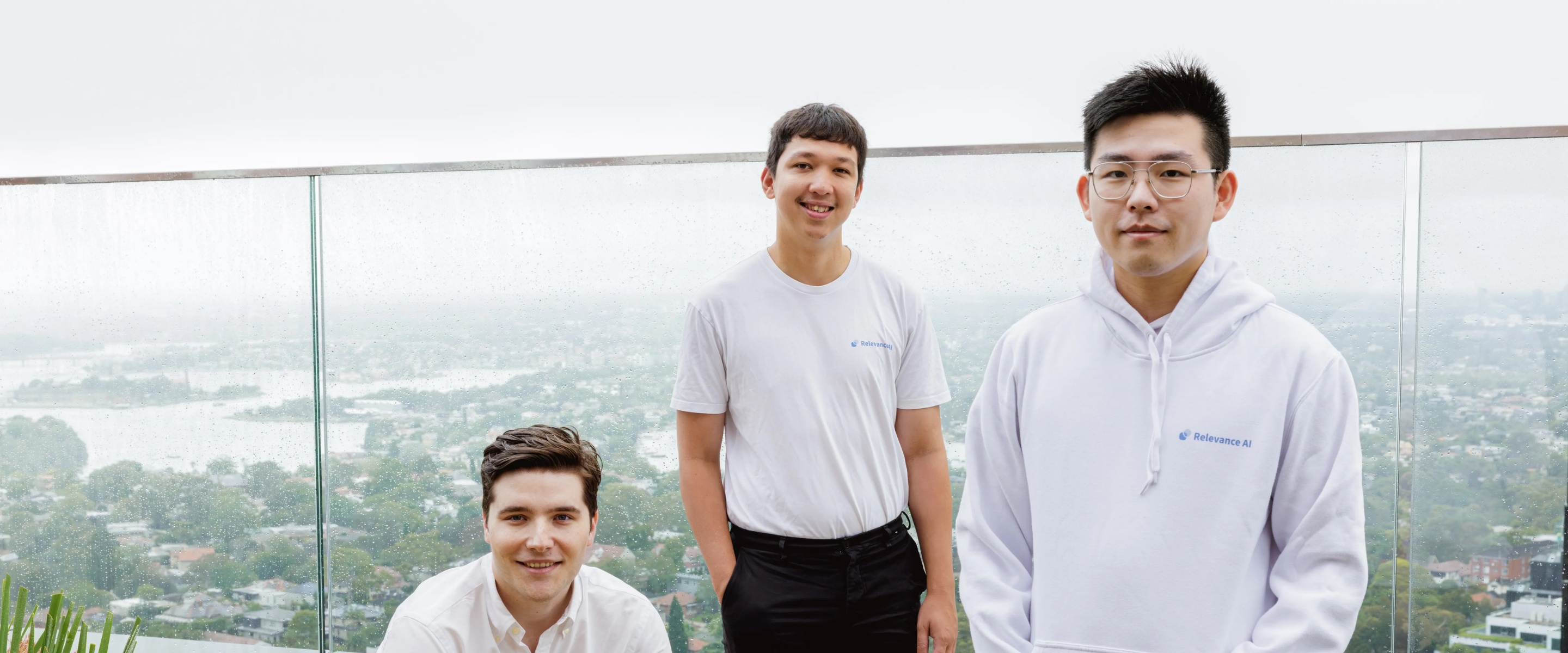 Relevance AI’s three co-founders on a terrace, with Jacky Koh at right