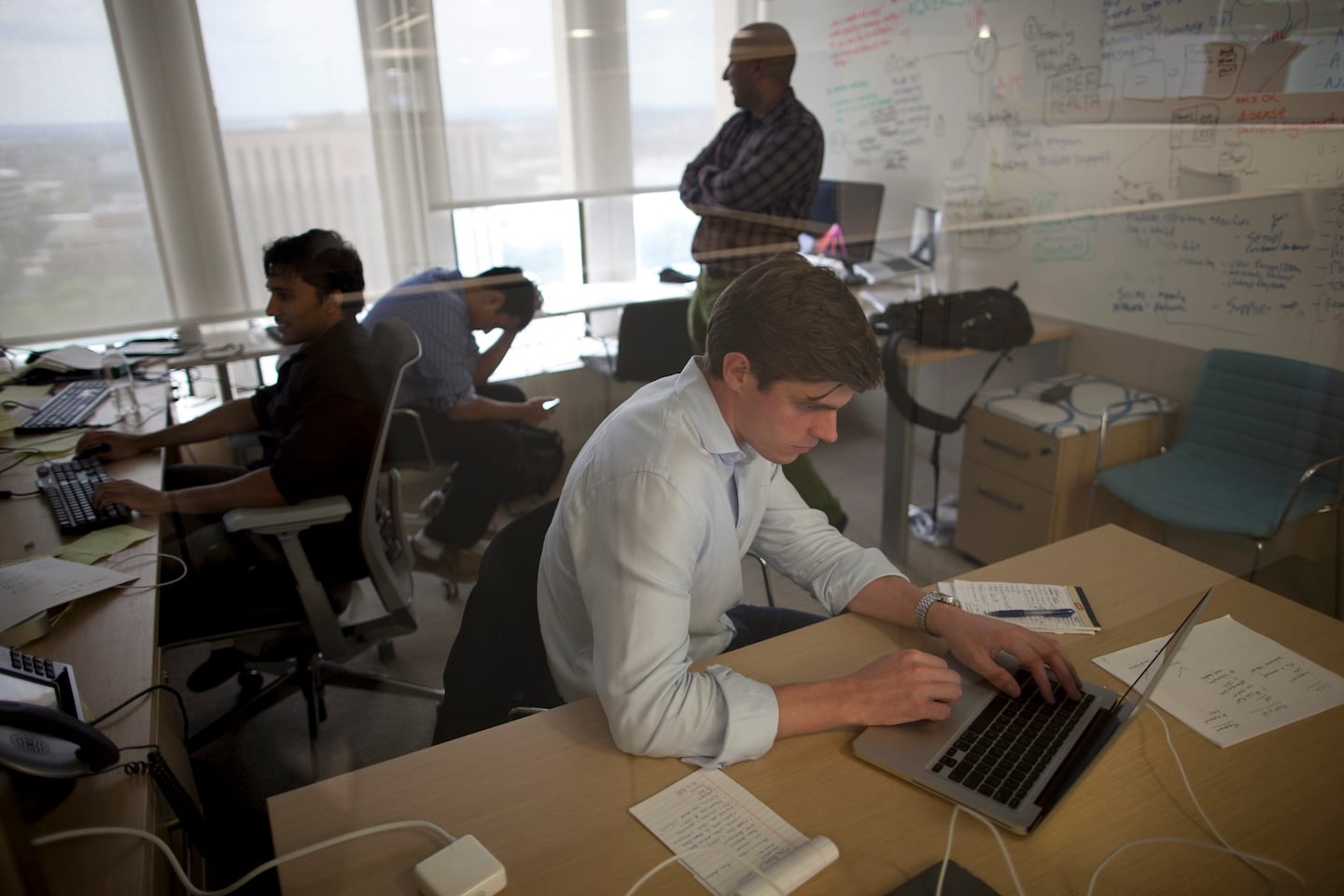 Jacob Sattelmair and his partners working at laptops in an office in 2012