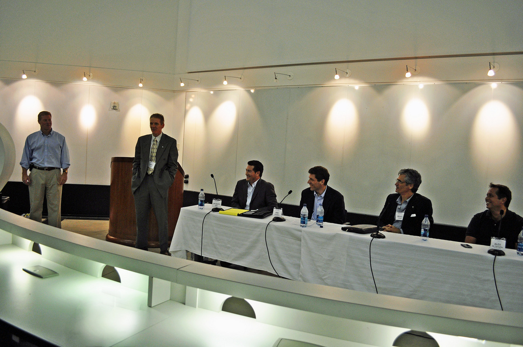 Internet marketing panelists seated at a long table during a Wharton Club event