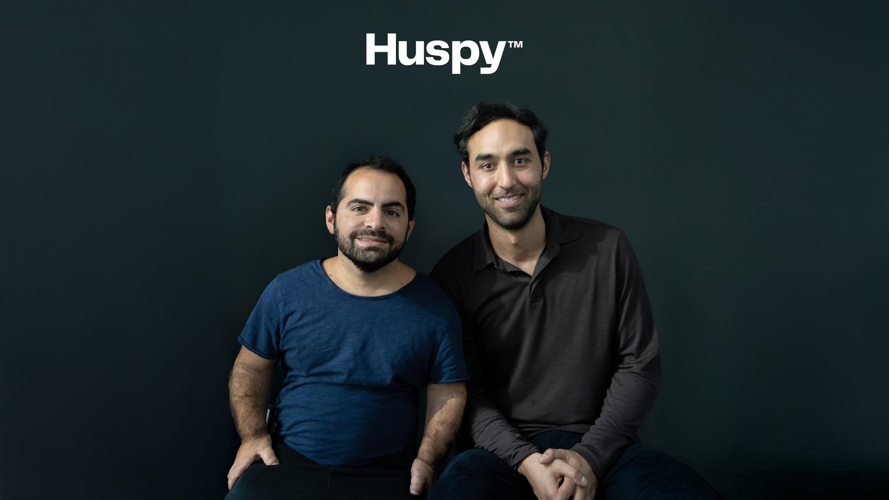 Jad Antoun, left, seated beside a fellow Huspy founder against a dark backdrop