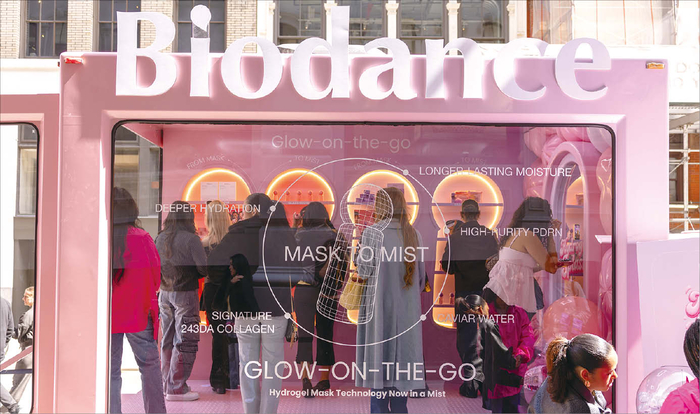 Visitors at a pink Biodance overseas pop-up display
