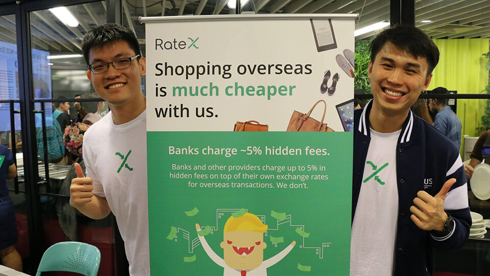 Davis Gay, left, and Jake Goh, right, beside a RateX display at The Hangar