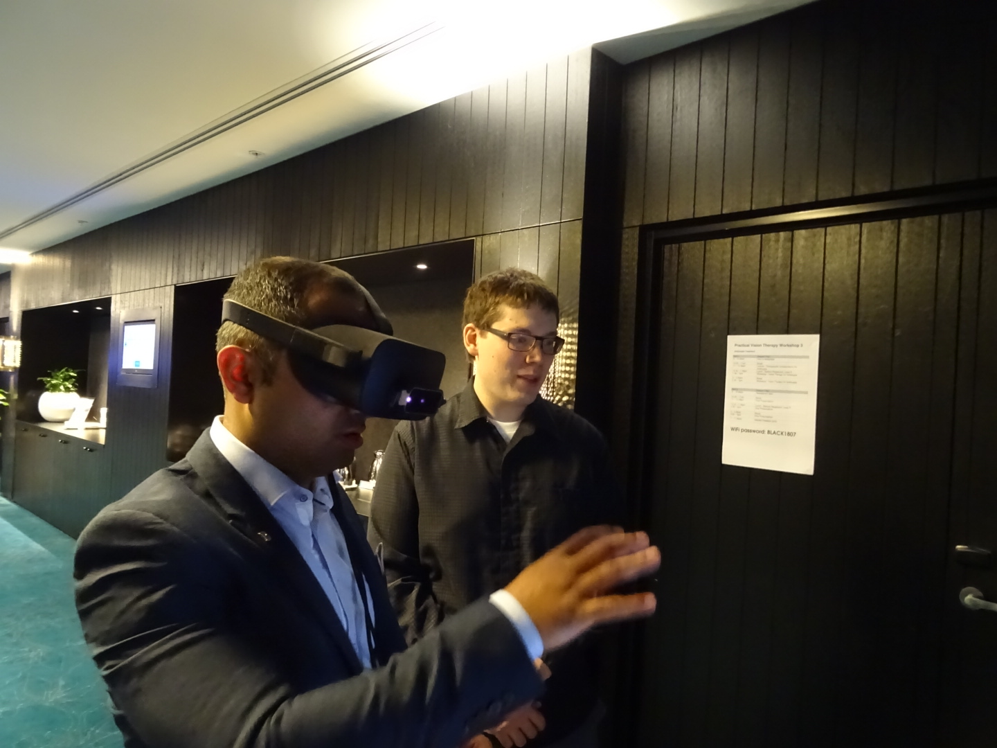 James Blaha watches a conference attendee use a virtual-reality headset during a demonstration in Sydney, Australia