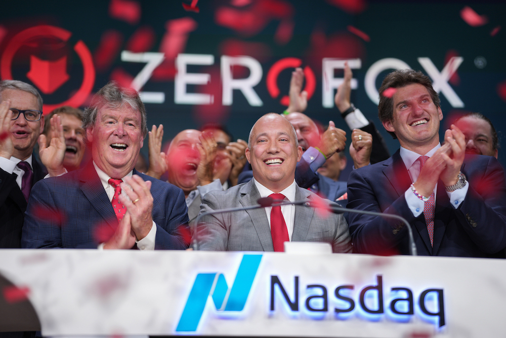 James Foster, center, celebrating ZeroFox's Nasdaq closing bell with colleagues beneath falling red confetti