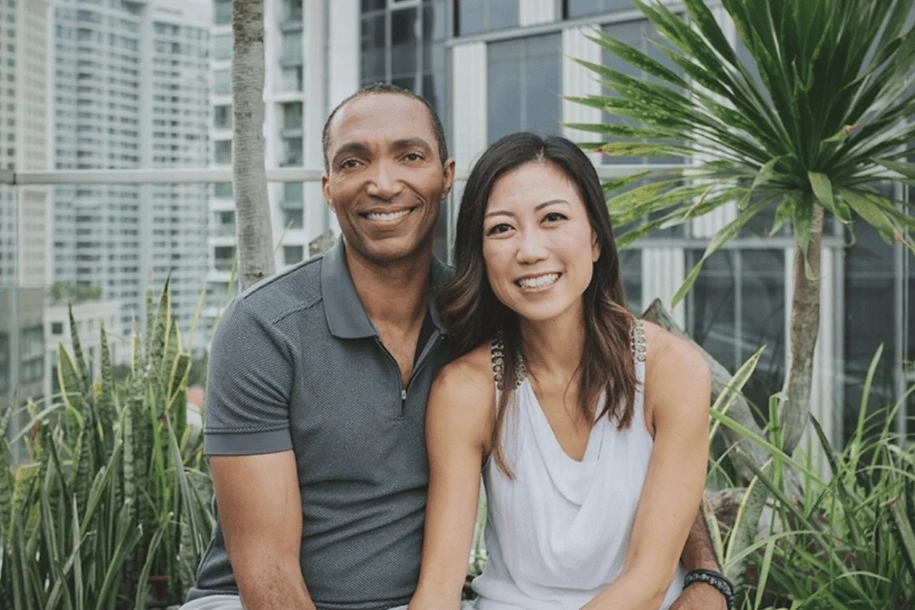 James Hare and Carolyn Lam seated together on a terrace