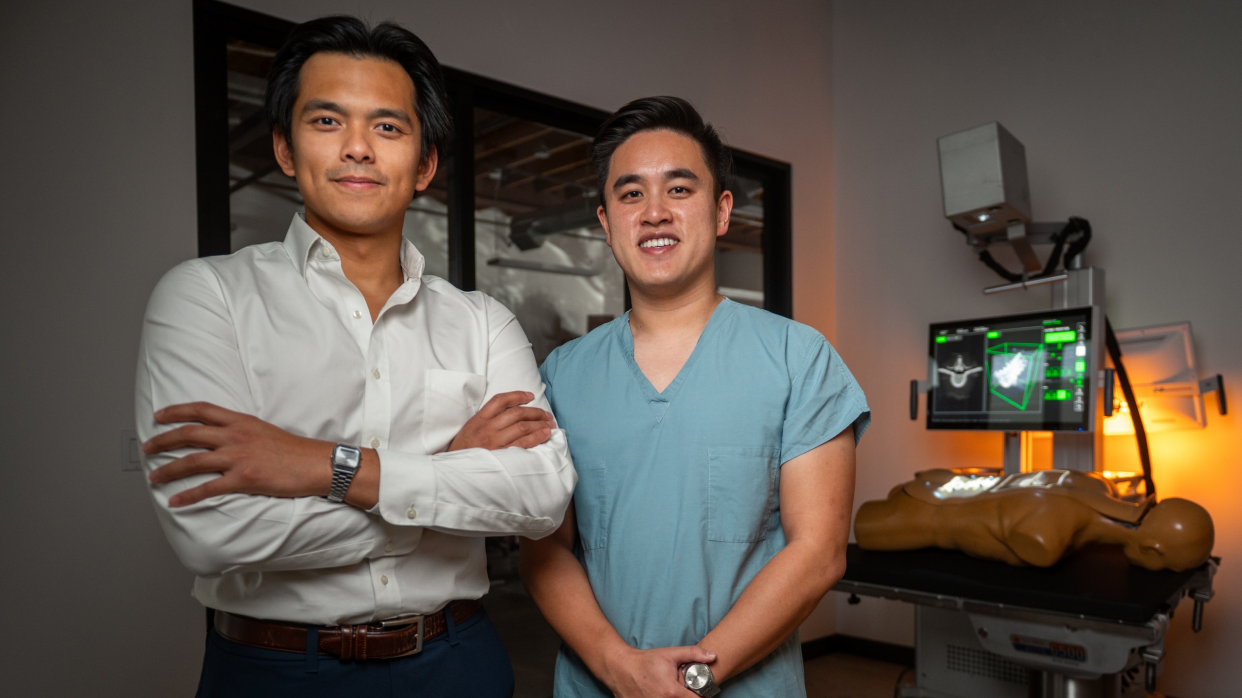 Illuminant co-founders Eldrick Millares, left, and James Hu, right, standing together at the company