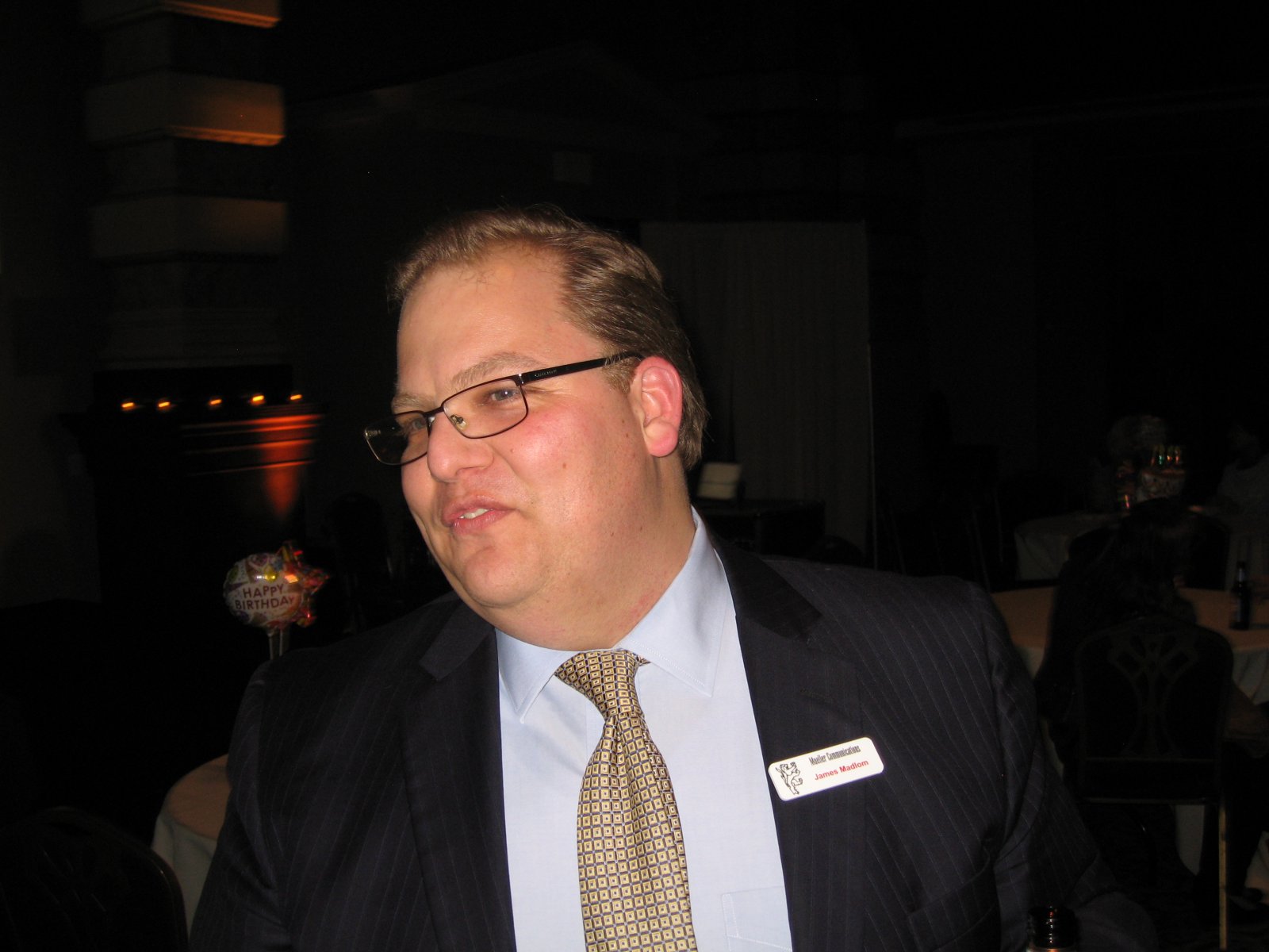 James Madlom wearing a Mueller Communications name badge at an event