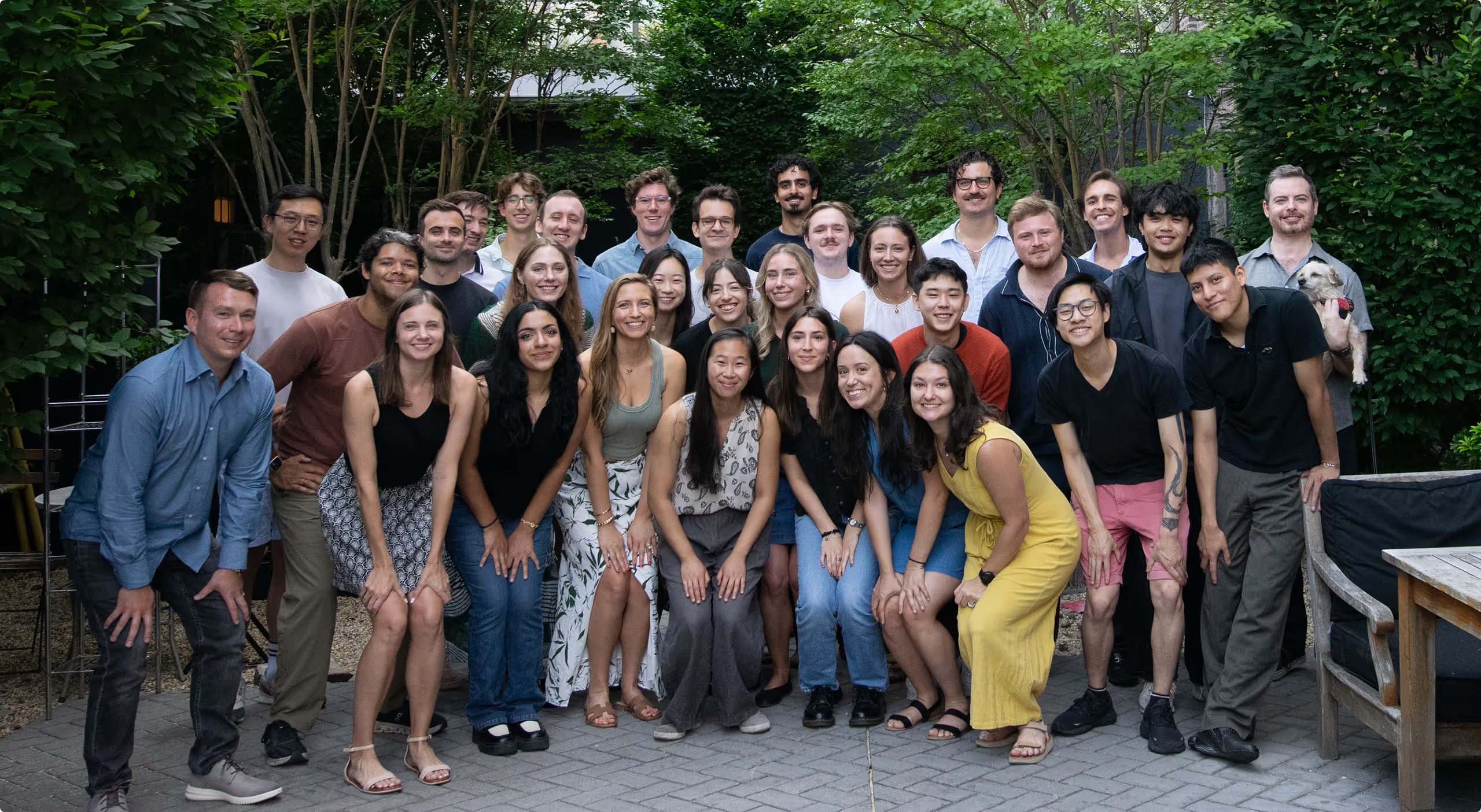 The Paces team gathered outdoors, with James McWalter at the far right holding a small dog