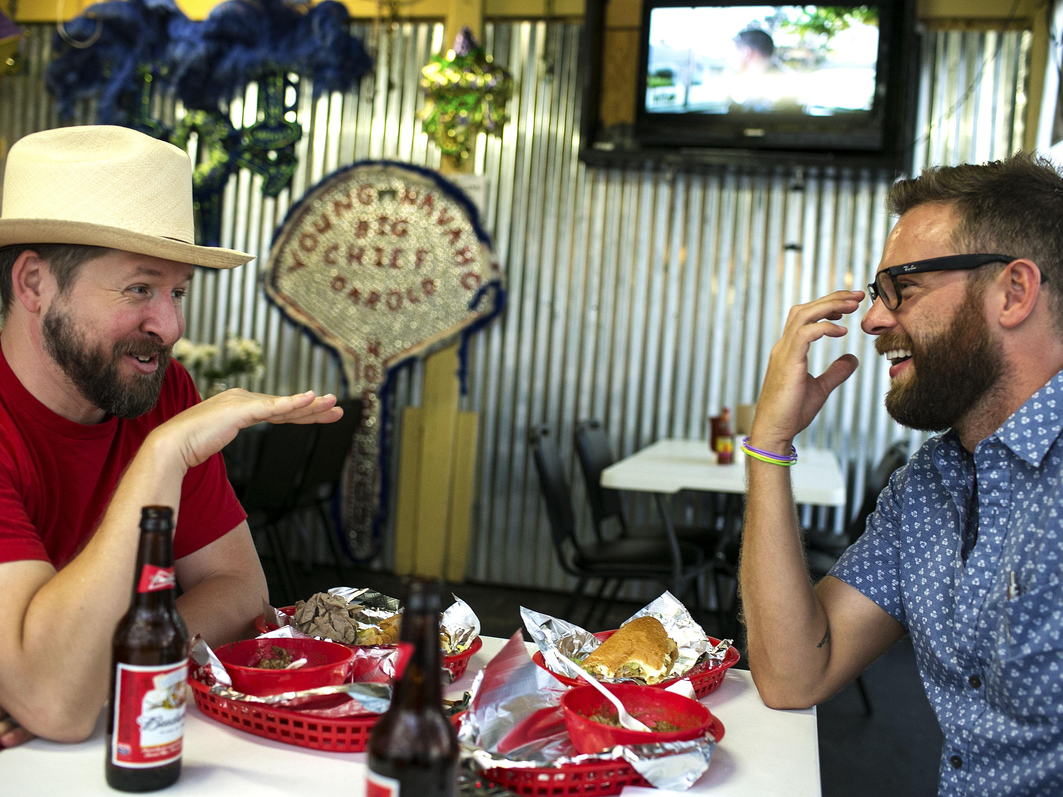 James Moody in his cowboy hat talking over a meal in Austin