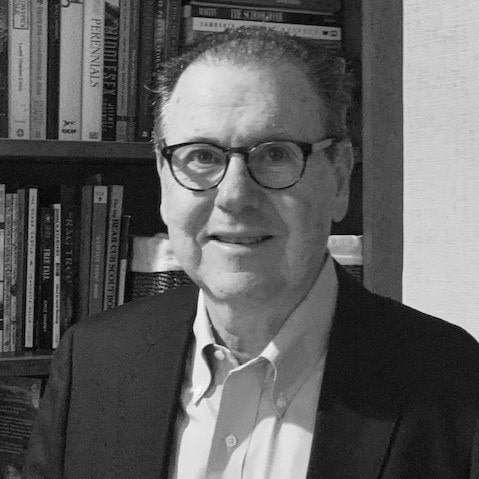 A separate black-and-white office photograph of James P. Smith seated in front of bookshelves