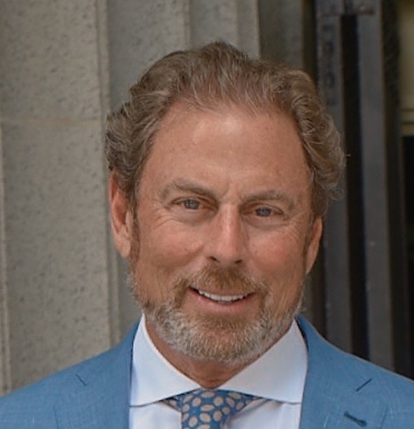 James Posada in a blue suit at a biotechnology conference