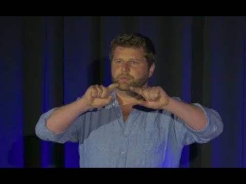 James Schmachtenberger speaking onstage during his 2017 TEDx talk